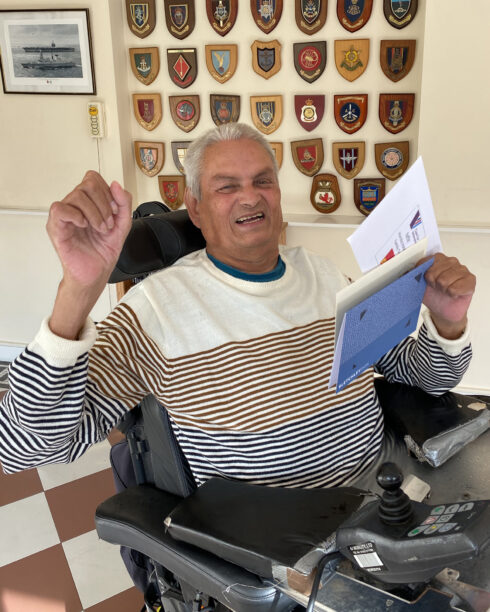 Care for Veterans resident, Dudley, with silent auction vouchers