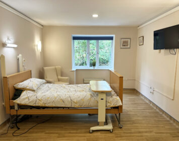 Single bedroom with armchair and TV